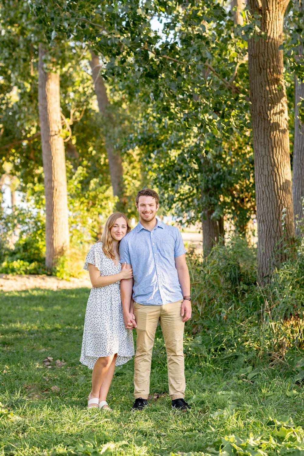 man in gray crew neck t-shirt standing beside woman in gray and white dress