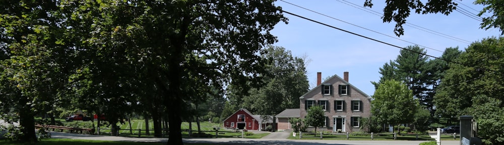 red and white house near green trees during daytime