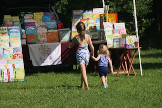 girl in white tank top standing beside girl in pink dress