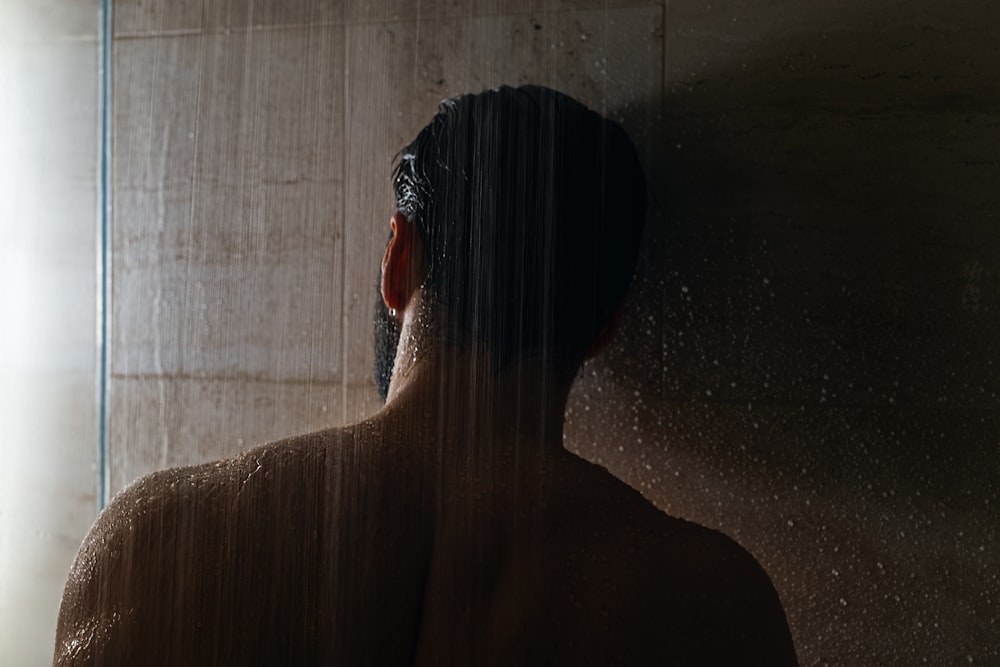 woman in black hair in front of white curtain