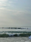 Surfers catching waves near the beach close to Jesolo Resort Arugambay.