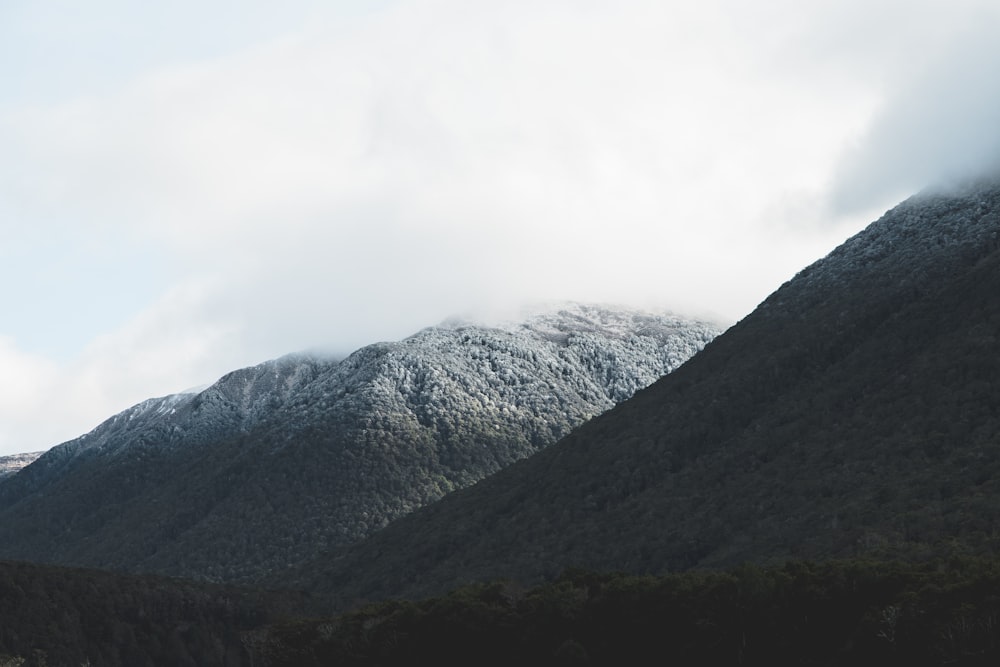 green and gray mountain under white clouds during daytime