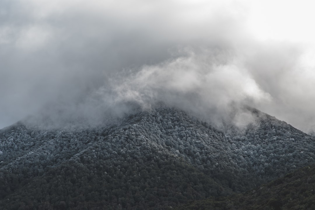 green mountain under white clouds during daytime