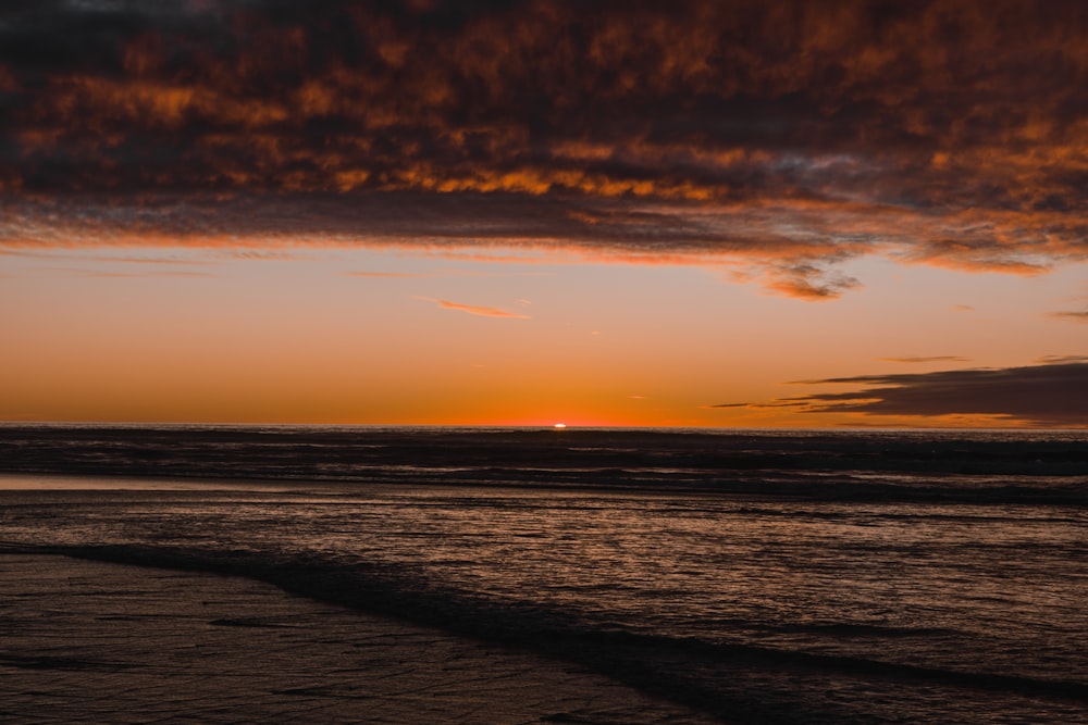 body of water during sunset