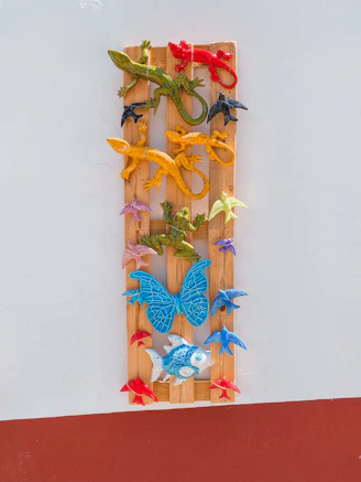 Brightly colored plaster molds shaped like animals and stars arranged on a wooden table.