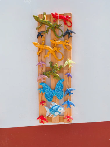 Brightly colored plaster molds shaped like animals and stars arranged on a wooden table.