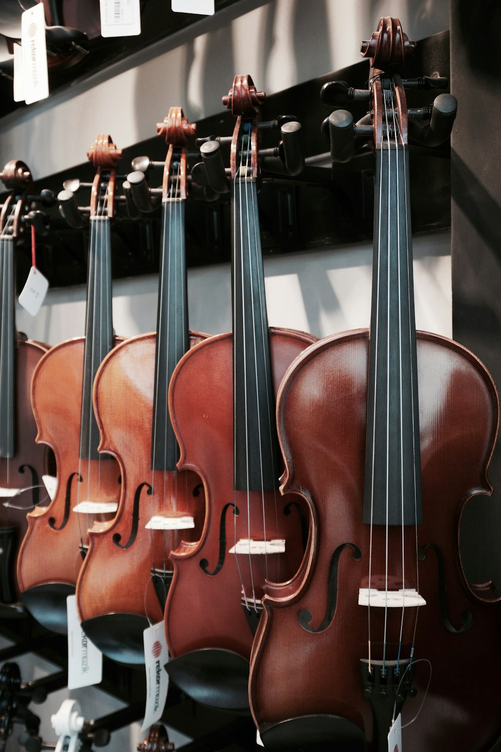 brown violin on black metal stand