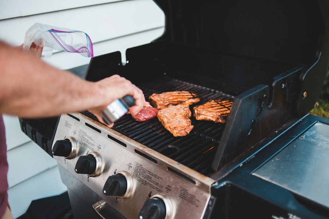 person holding a grilled meat