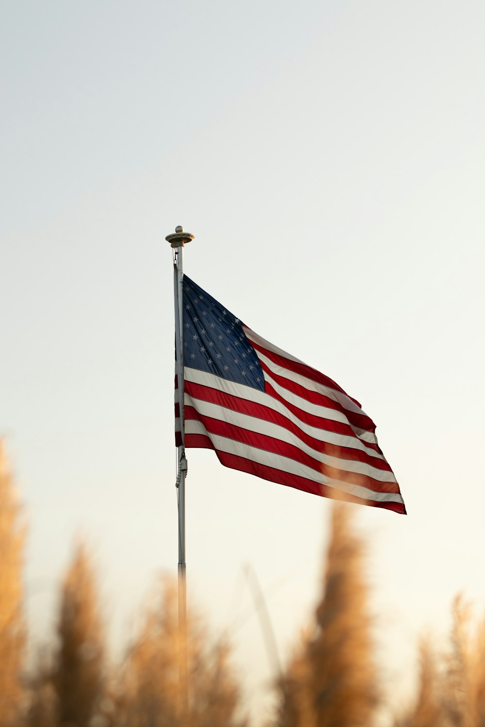 us a flag on pole during daytime