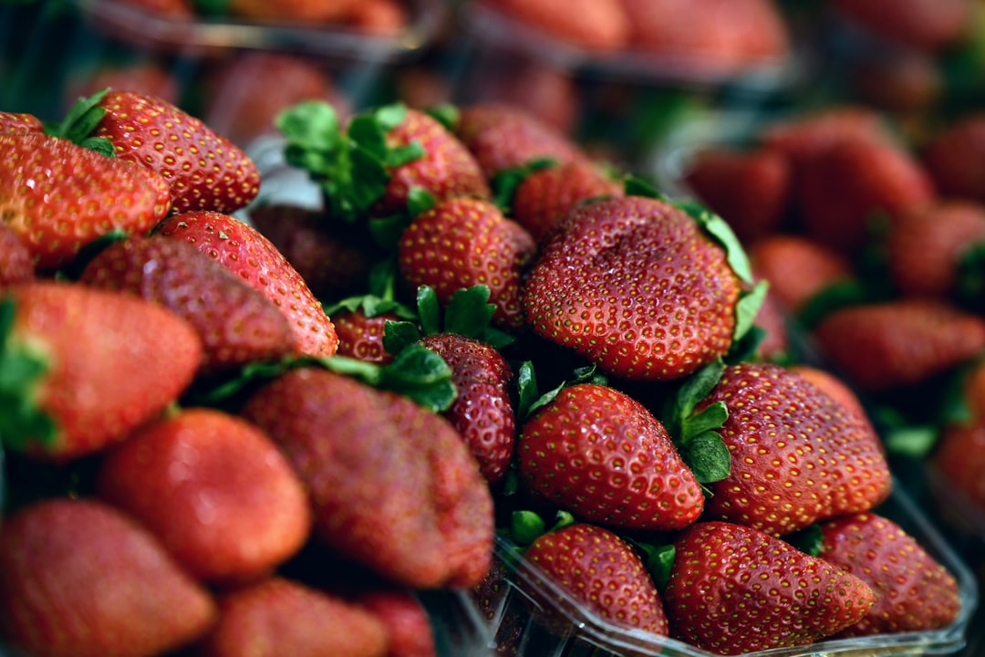 red strawberries in clear glass bowl