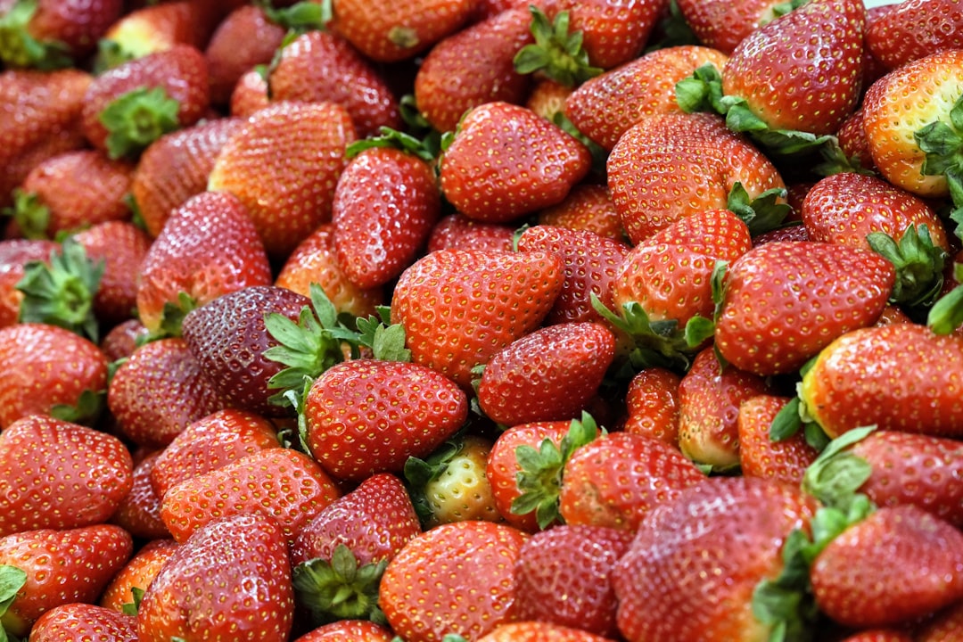 red strawberries on green leaves