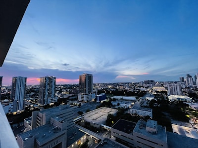 A city skyline featuring high-rise real estate buildings at sunset.
