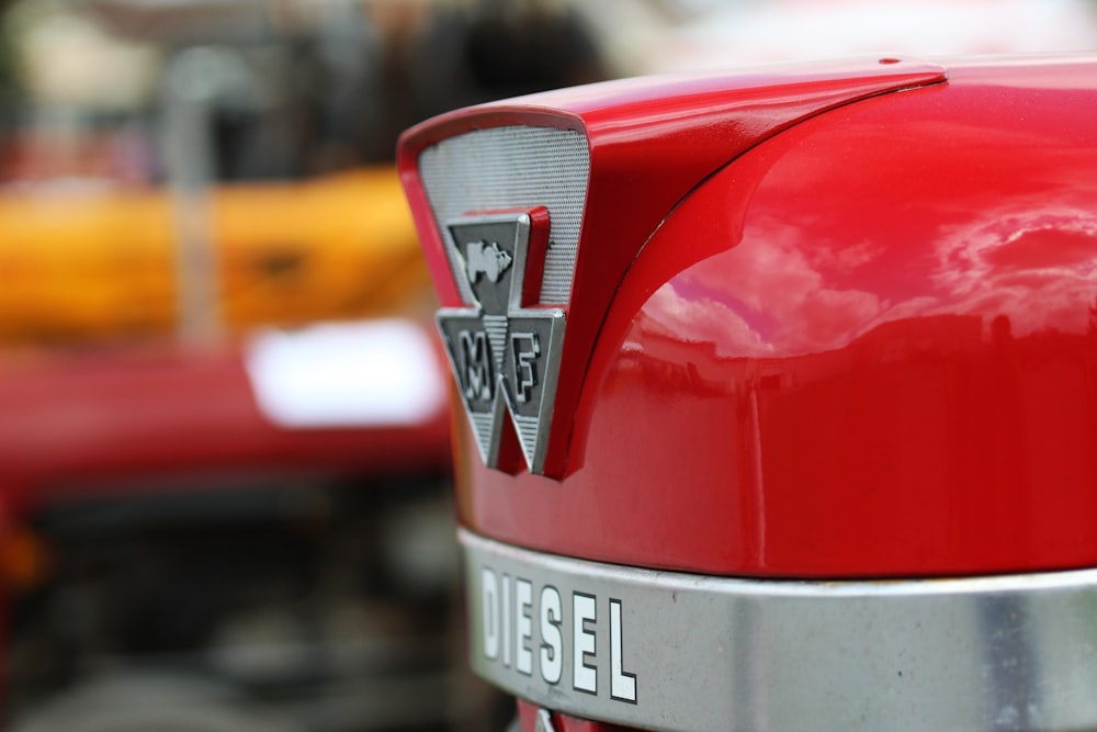 a close up of the emblem on a red vehicle