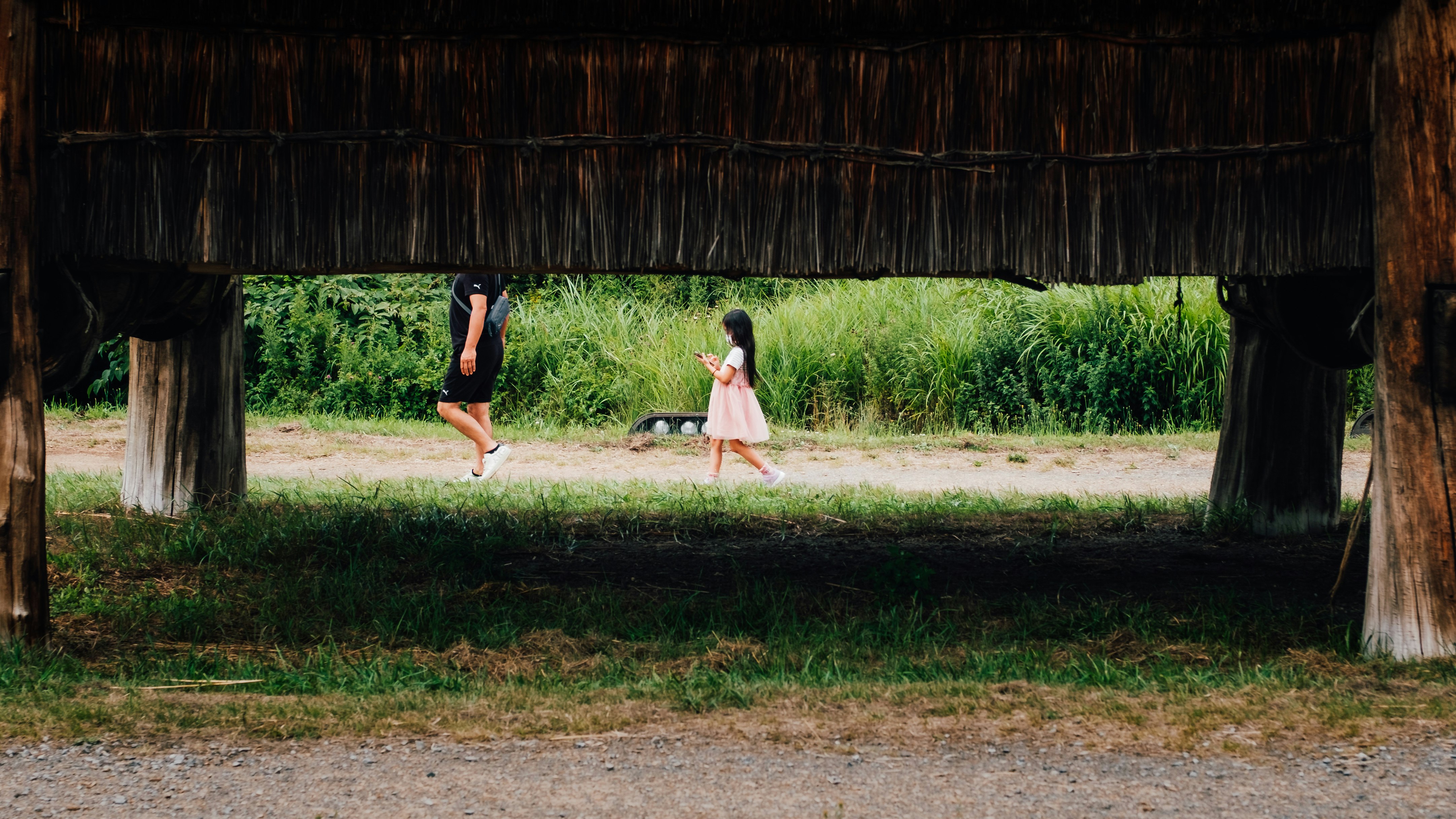 2 girls playing on green grass field during daytime