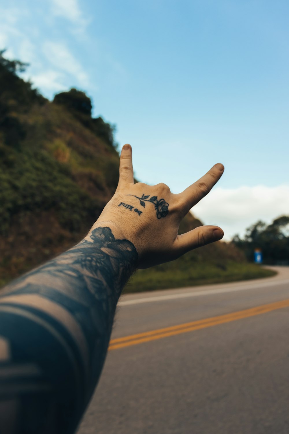 person with i love you hand tattoo