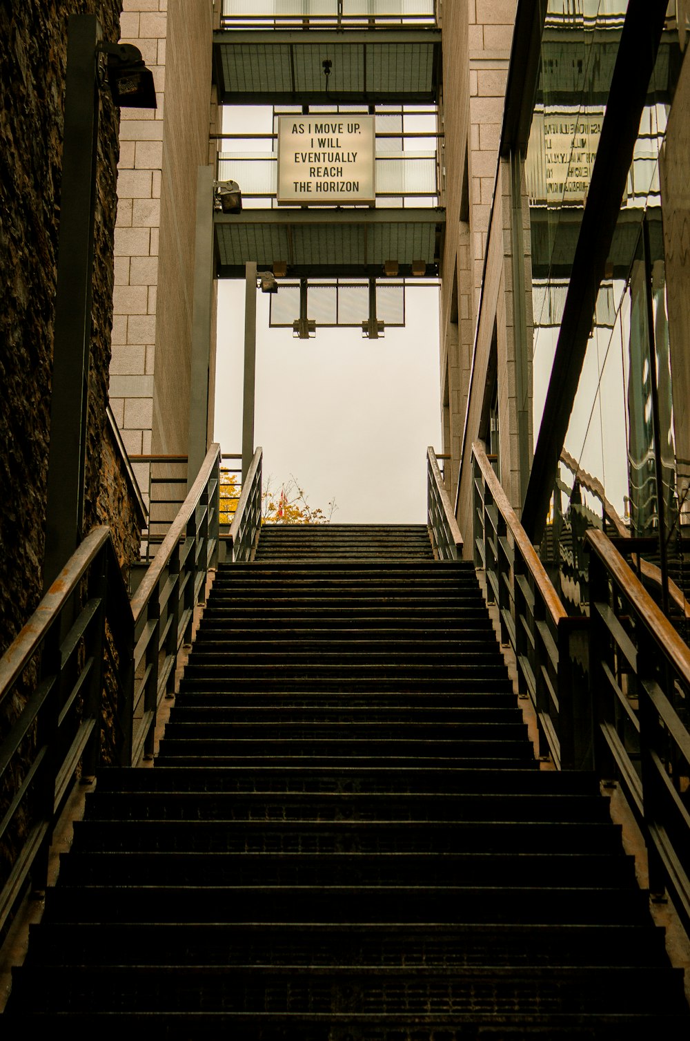 brown wooden staircase near glass window