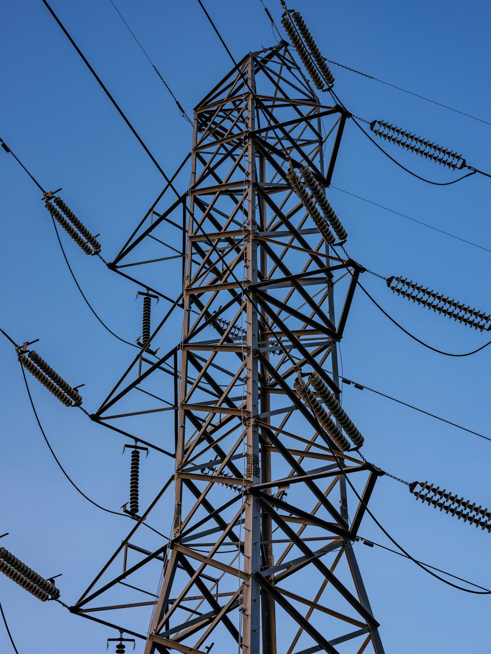 black electric towers under blue sky during daytime