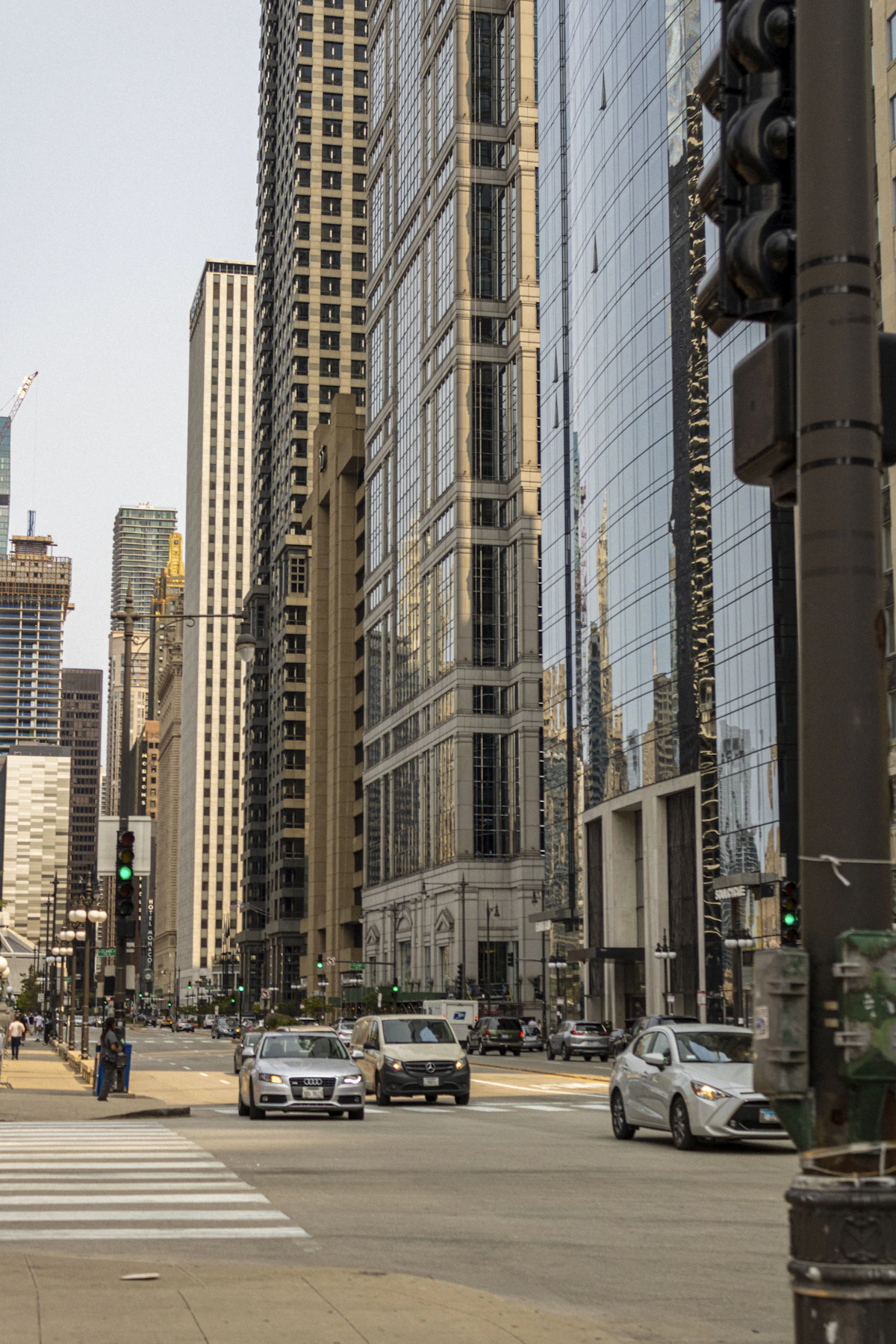 High-rise glass towers of a major financial district seen from street level — illustrative imagery of the global wealth concentration captured by the Forbes 40th annual World's Billionaires List published March 10, 2026, which recorded 3,428 billionaires worth a combined $20.1 trillion.