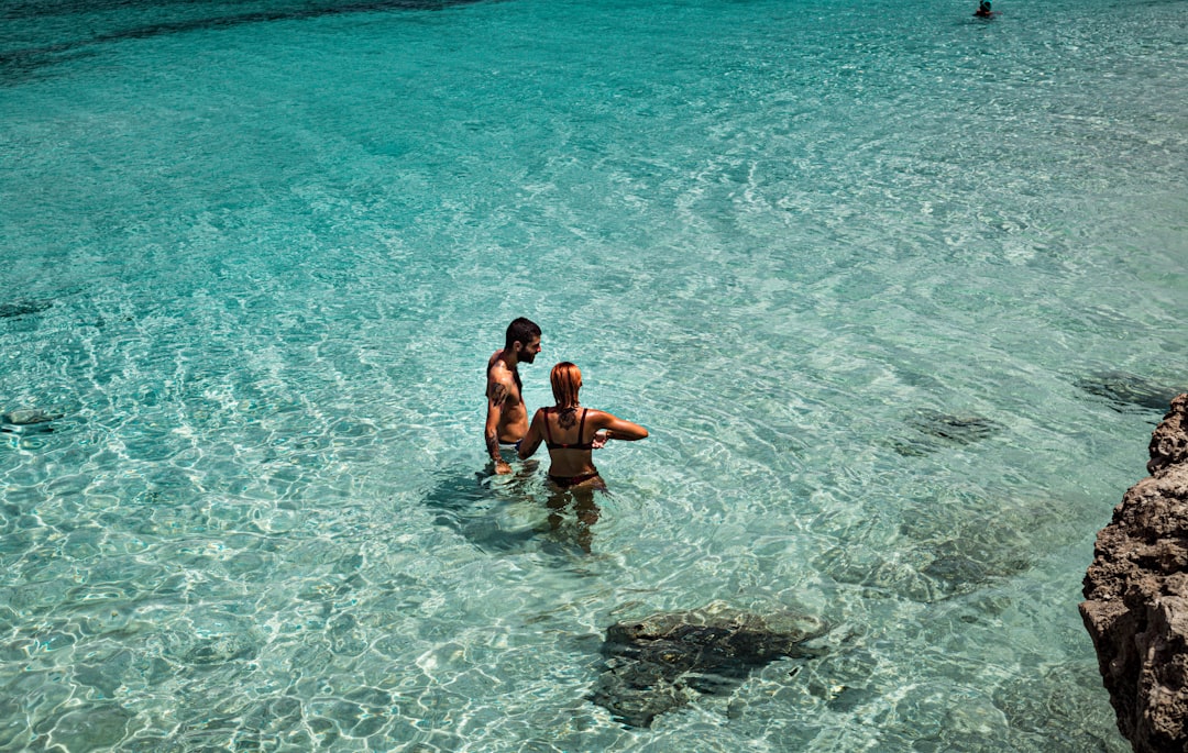 2 boys in water during daytime