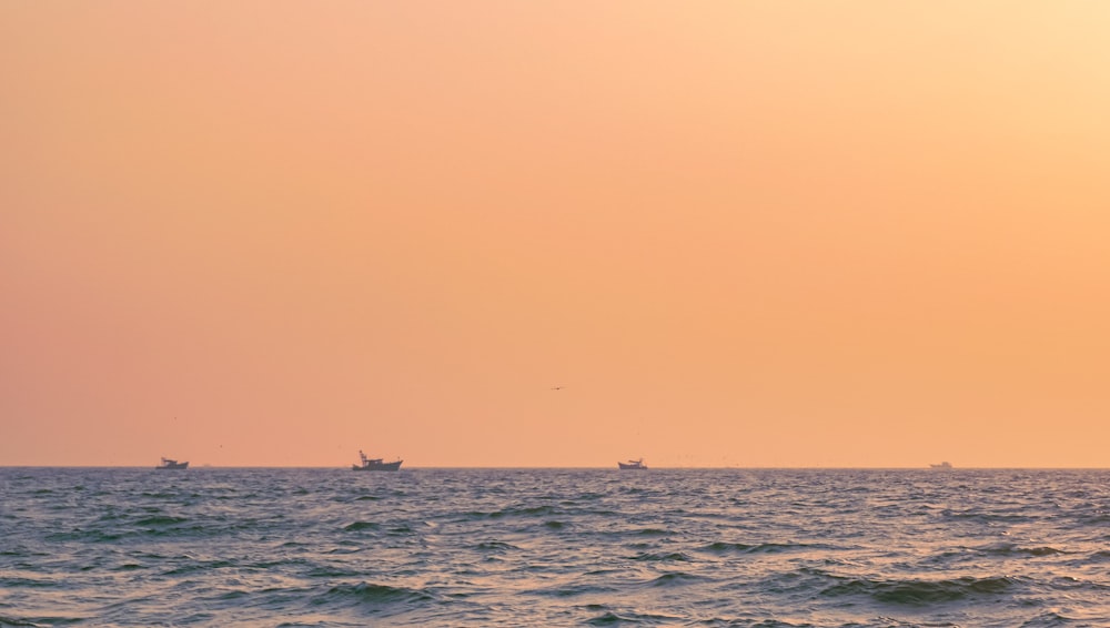 boat on sea under blue sky during daytime