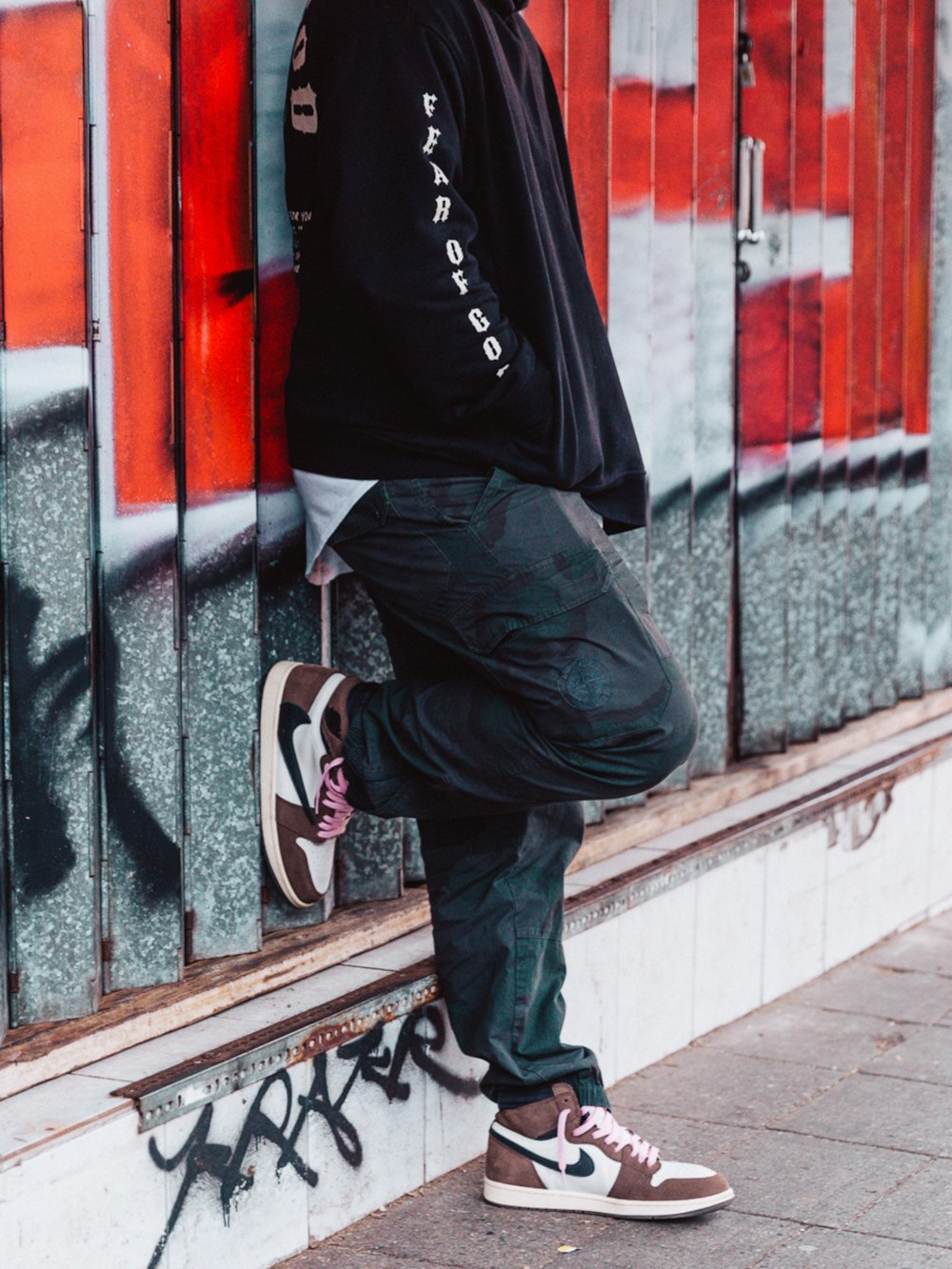 man in black and white nike basketball shoes and black pants