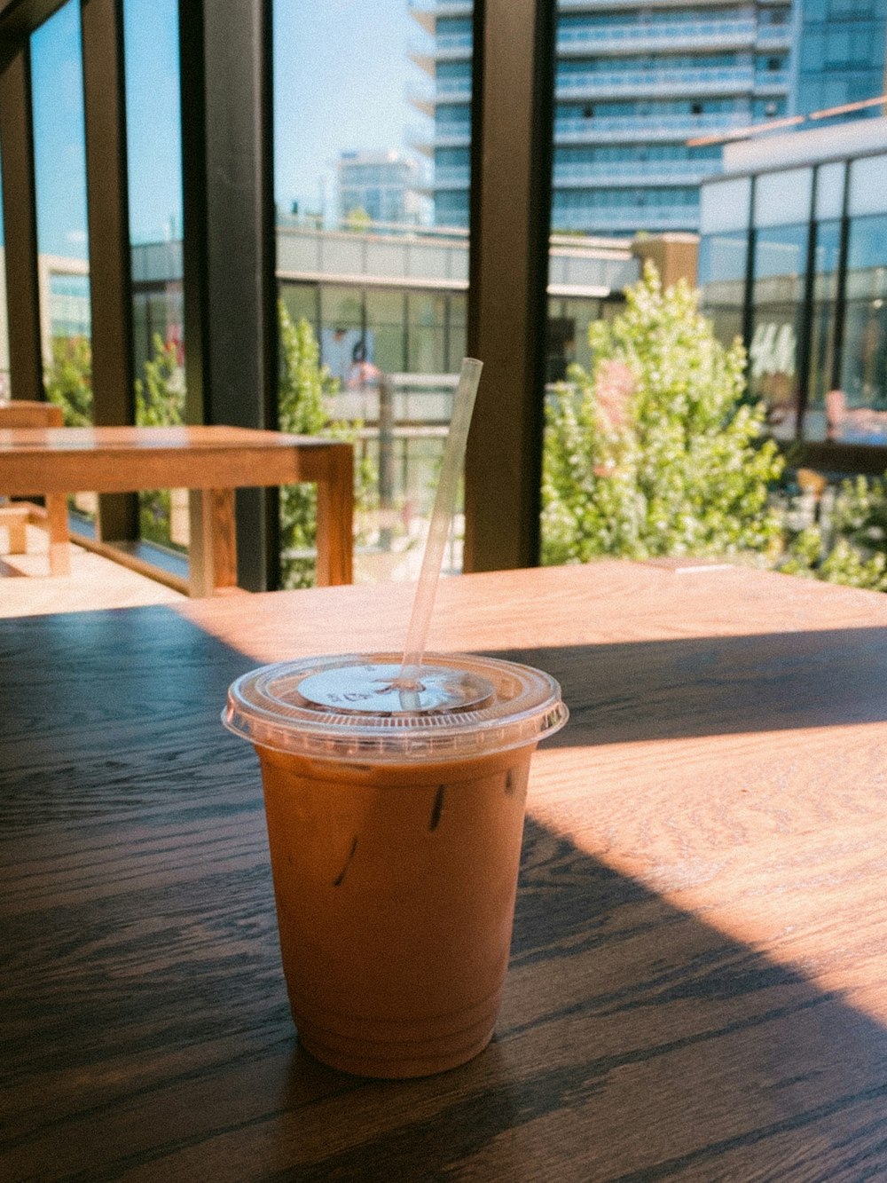 brown and white disposable cup on brown wooden table