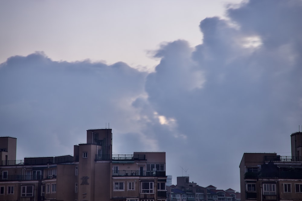 brown concrete building under white clouds during daytime