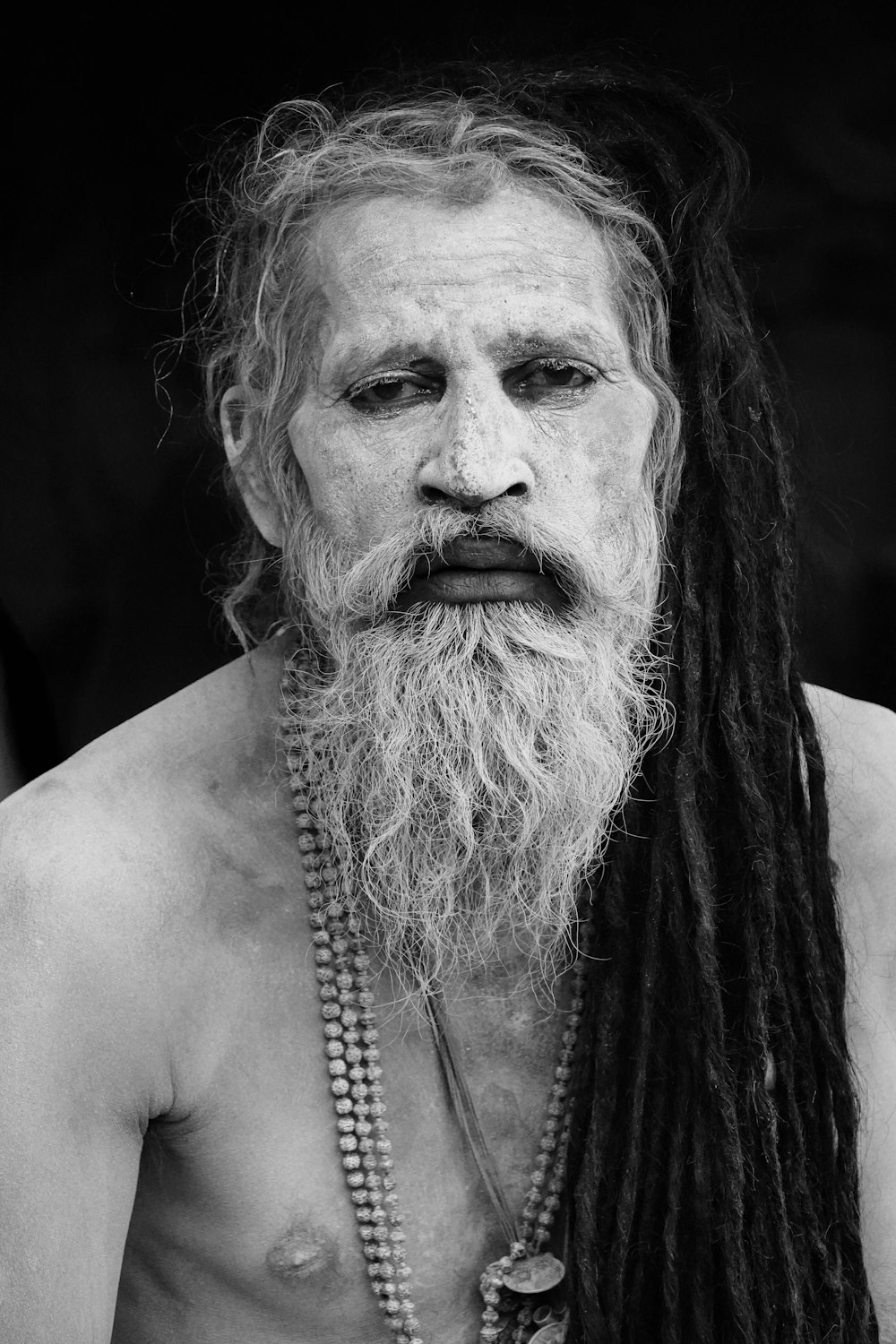 topless man with silver chain necklace