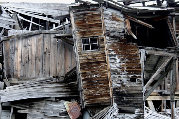 A half-built wooden contraption leaning precariously against a cluttered corner.