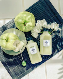 green apple beside white plastic bottle