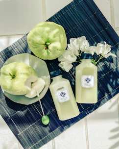 green apple beside white plastic bottle