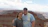 Smiling couple enjoying a scenic view of the Colca Canyon at sunset.