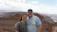 Smiling couple enjoying a scenic view of the Colca Canyon at sunset.