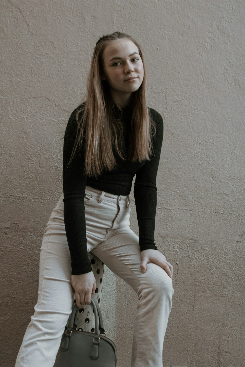 woman in black long sleeve shirt and white pants