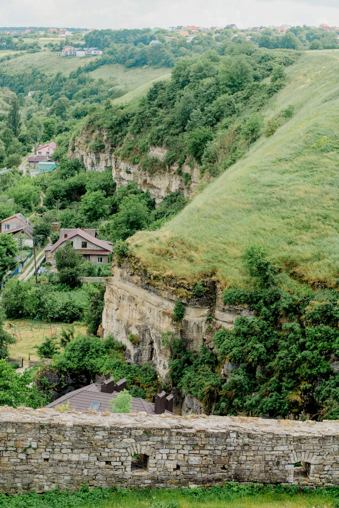 green mountain with houses during daytime