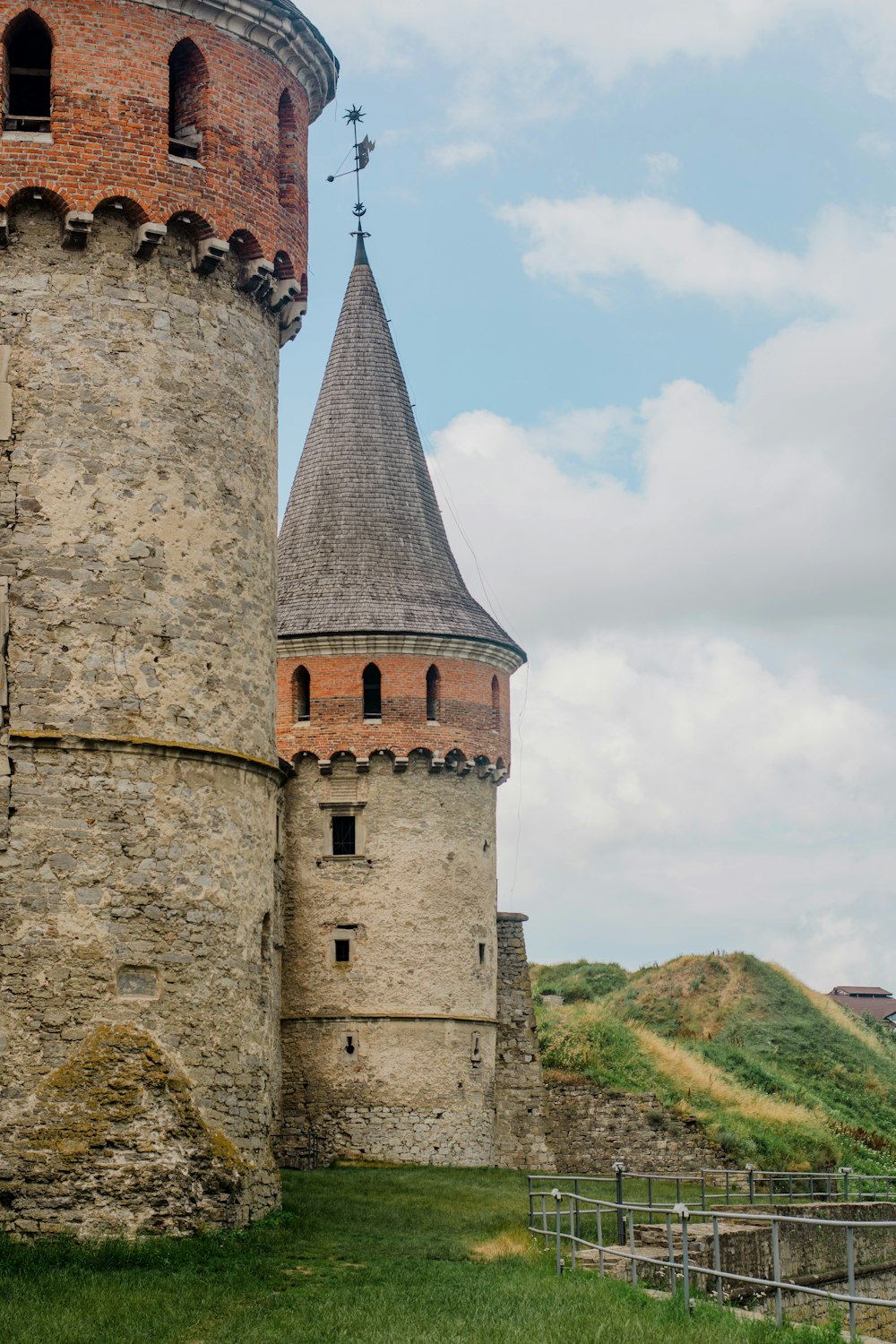 brown concrete castle under white clouds during daytime