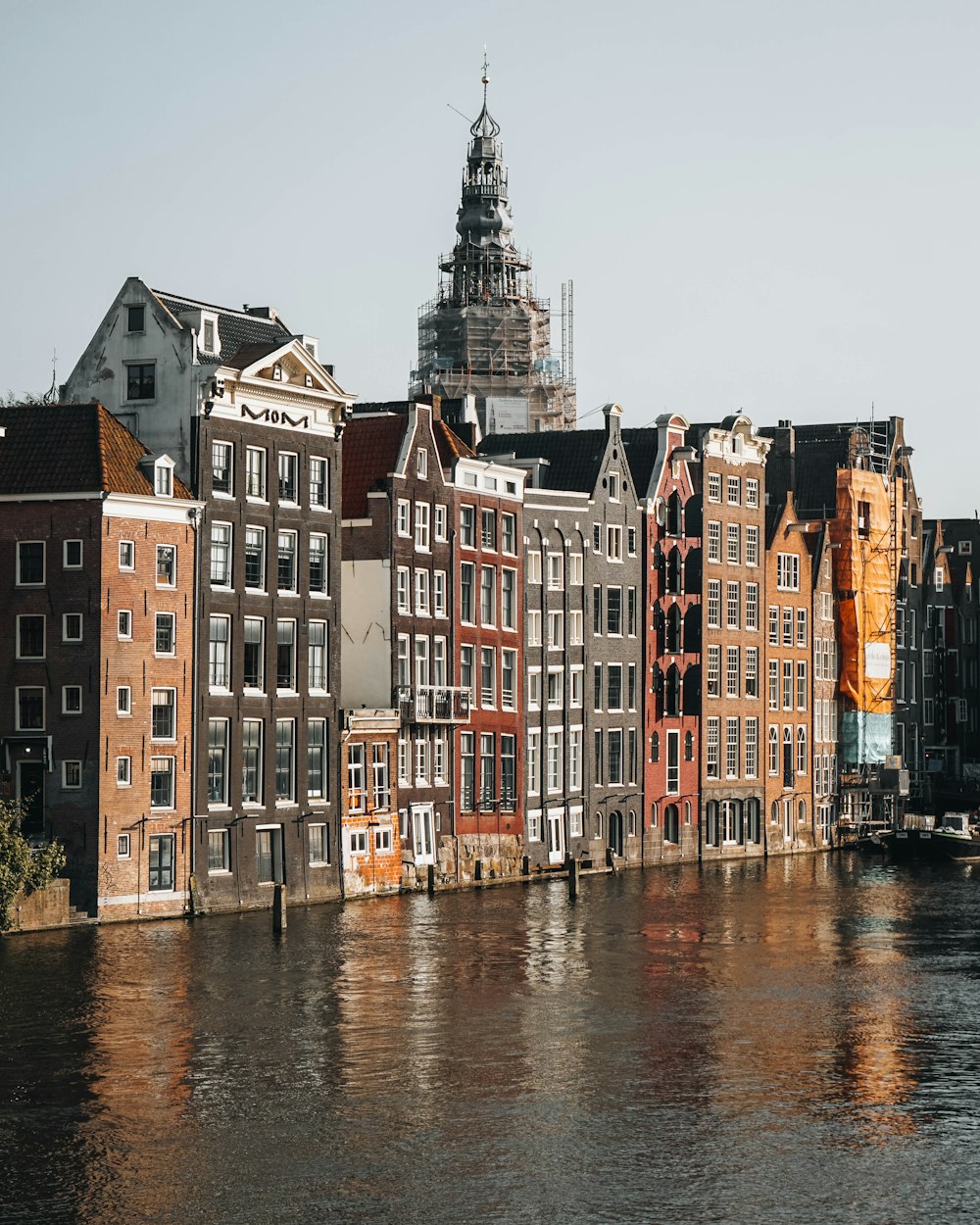 brown and white concrete building beside river during daytime