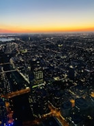 A vibrant aerial shot captured by drone over a bustling cityscape at sunset.
