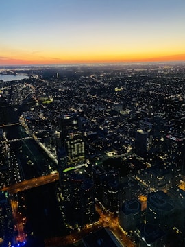 A vibrant aerial shot captured by drone over a bustling cityscape at sunset.