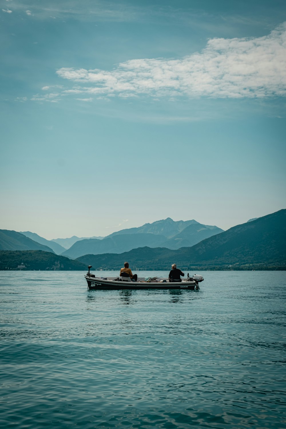 2 people riding on boat on sea during daytime