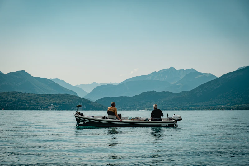 A small group relaxing on a boat on calm coastal water