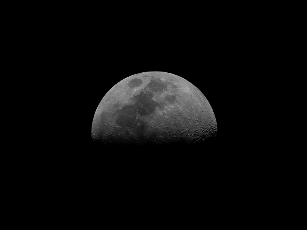 grayscale photo of moon in dark room