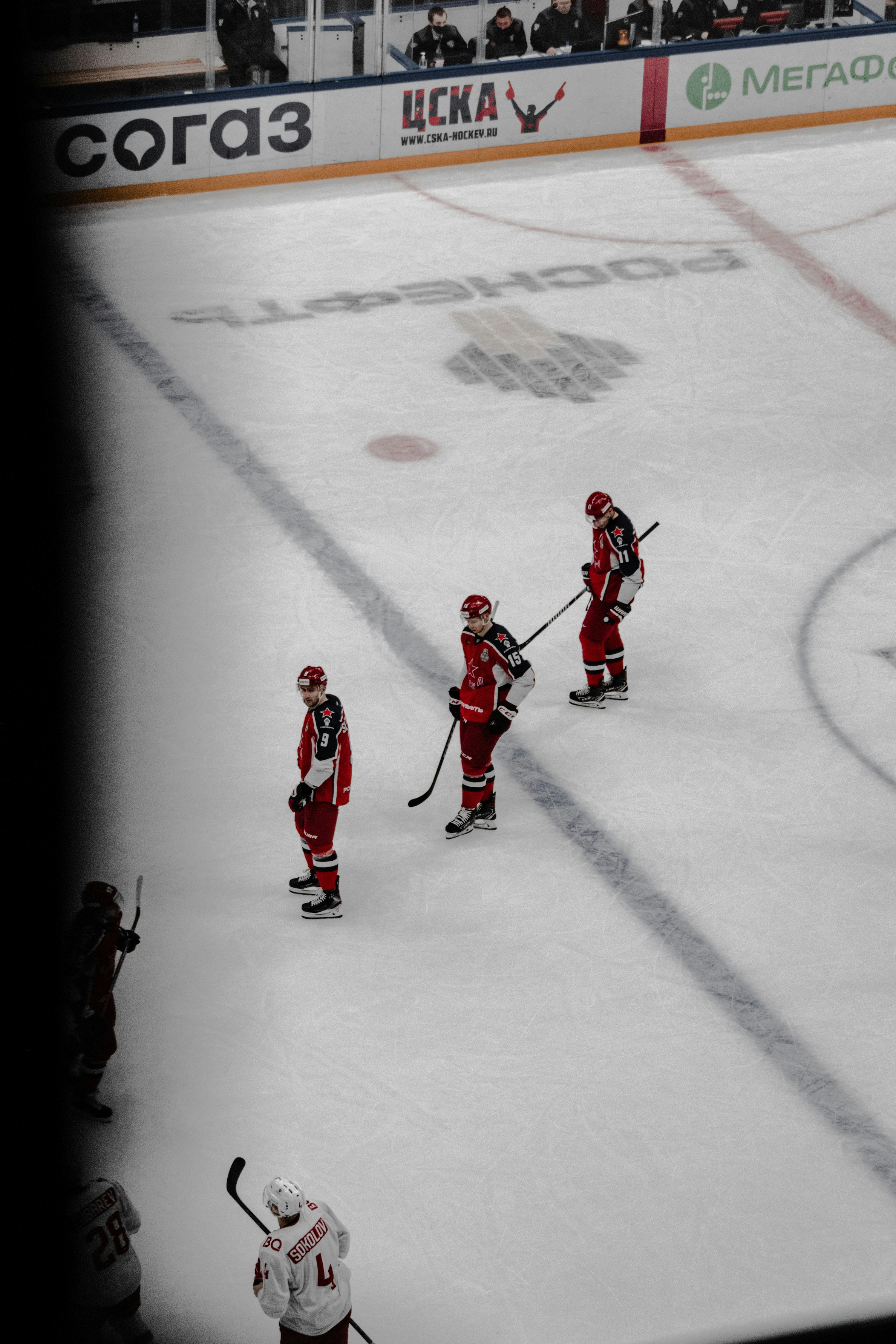 3 men in red and white ice hockey jersey playing on ice field