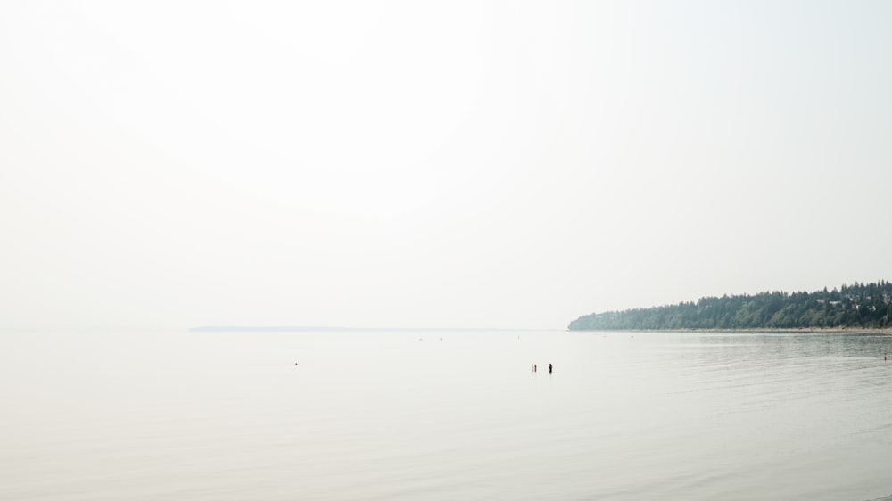 body of water near mountain during daytime