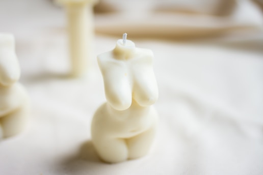 white candle on white textile