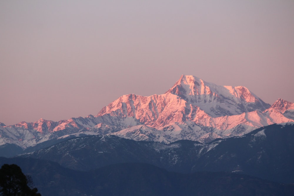 montagna marrone e bianca sotto il cielo grigio