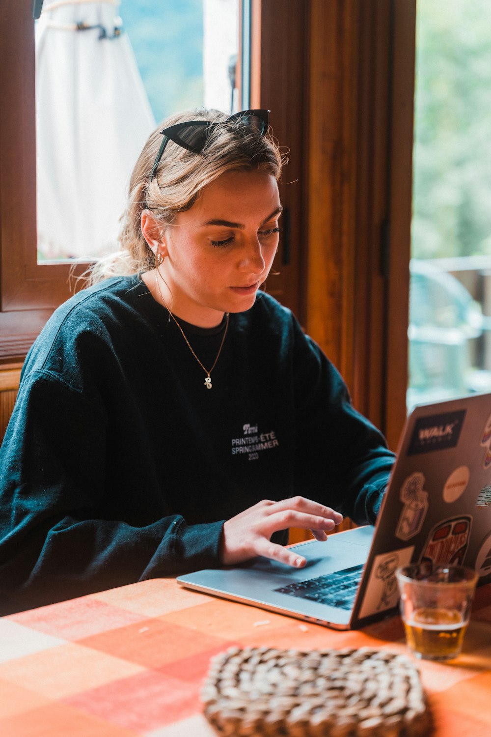 woman in blue sweater using tablet computer