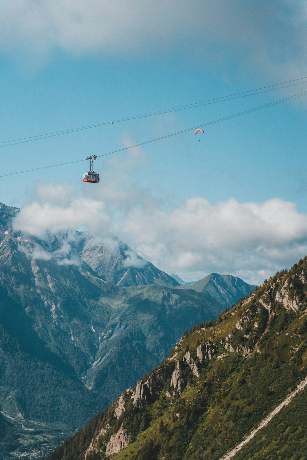 red cable car over snow covered mountain