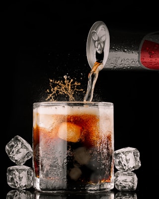 clear drinking glass with brown liquid