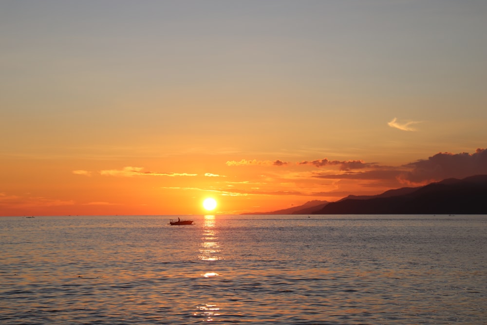 body of water during sunset